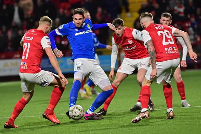 Linfield's Kyle Lafferty under pressure from Larne players in the Premiership scoreless draw