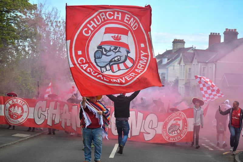 Fans of Larne march to the stadium before this evening's game