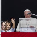Pope Francis, flanked by children from the five continents, speaks during Sunday’s noon blessing in St Peter’s Square at The Vatican (AP Photo/Riccardo De Luca)