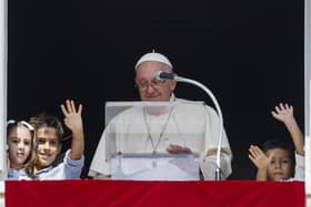 Pope Francis, flanked by children from the five continents, speaks during Sunday’s noon blessing in St Peter’s Square at The Vatican (AP Photo/Riccardo De Luca)