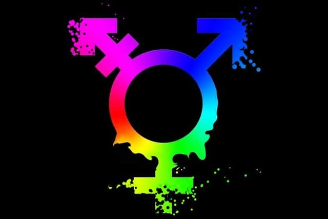 Graphic of a disintegrating male/female gender symbol