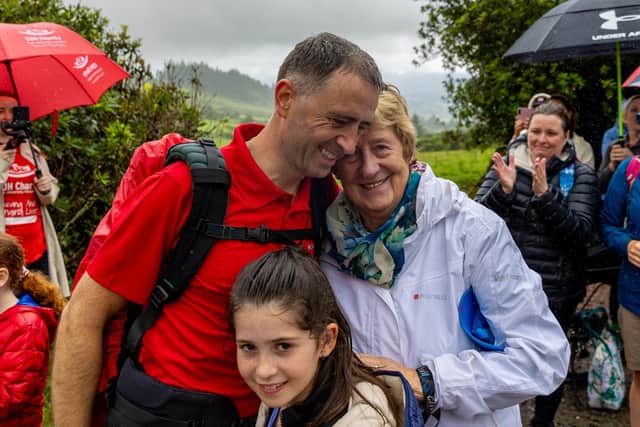 Dr Richard Horgan being embraced by Ms Gosnell's mum Myriam after making his final descent from Galtymore, after climbing highest peaks in the 32 counties across the island of Ireland