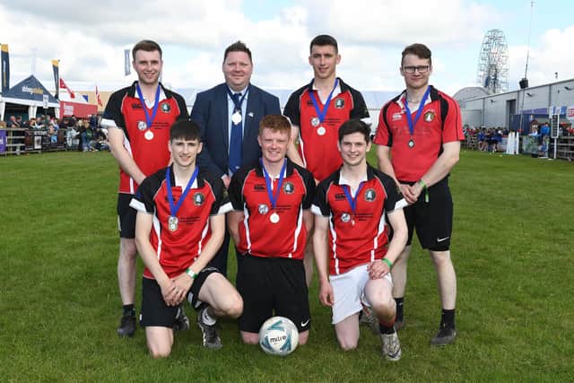 Men's five-a-side football winners, Gleno Valley YFC with president Stuart Mills. The finals were held at this year's Balmoral Show