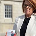 Kate Corrigan, holding a picture of her son Nathan who was killed in a crash on the A5 in December 2001, from the Enough is Enough group outside Parliament Buildings, Stormont after their meeting with infrastructure minister John O'Dowd