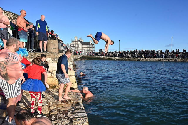 Leaping into 2024 at the annual New Year's Day swim in Carnlough, Co. Antrim, Northern Ireland.