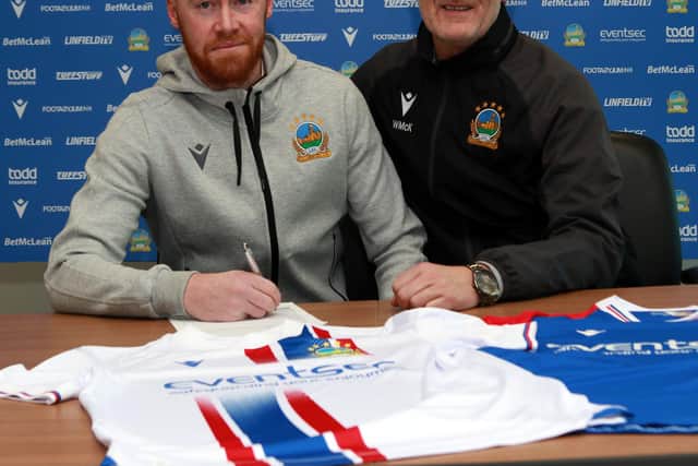 Chris Shields pictured with Linfield chief scout Willie McKeown after signing his contract extension. PIC: Pacemaker