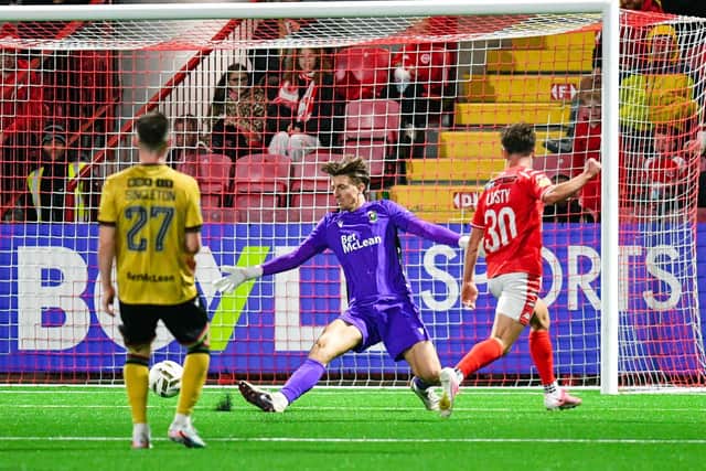 Matty Lusty slots home Larne's second after a defensive mistake from Glentoran. (Photo by Andrew McCarroll/Pacemaker Press)