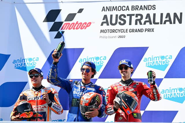 Australian Grand Prix winner Alex Rins on the podium with runner-up Marc Marquez (left) and Pecco Bagnaia.