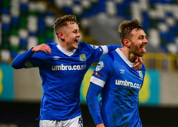 Linfield's Robbie McDaid is joined by Liam McStavick to celebrate Linfield's third goal against Carrick Rangers on Saturday at Windsor Park.