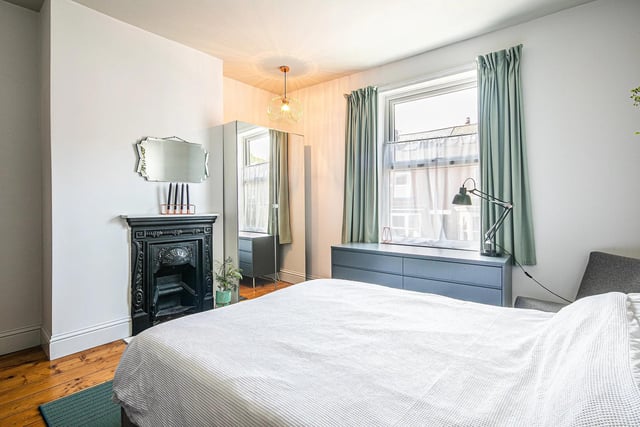 This double bedroom has a lovely feature fireplace and wooden floor.