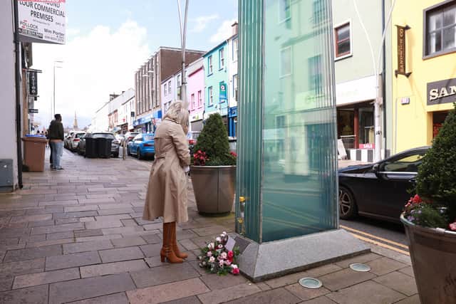 Caroline Martin sister of Esther Gibson who died in the Omagh bombing lays flowers at the site of the bombing to mark the 25th anniversary of the Real IRA atrocity. Picture date: Tuesday August 15, 2023. Photo: Liam McBurney/PA Wire