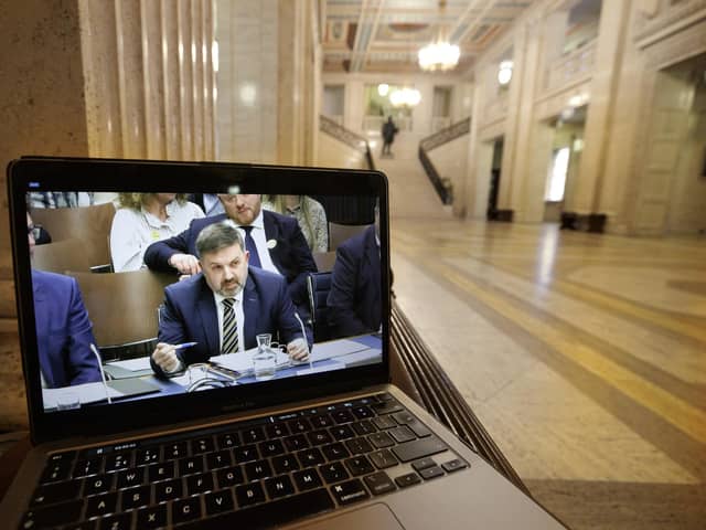 A laptop screen in the Great Hall at Parliament Buildings at Stormont shows a live feed of Minister for Health Robin Swann