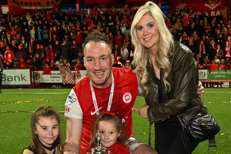 Larne defender Albert Watson celebrates the Premiership success with his family