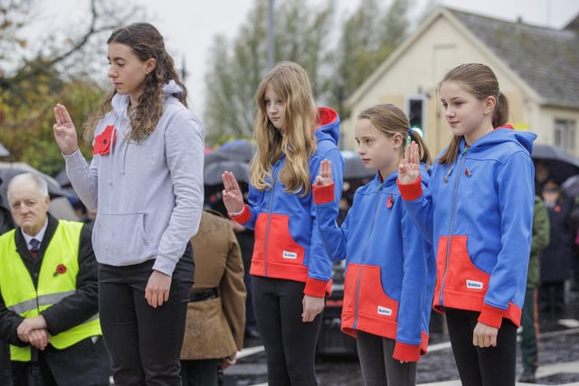 (from left) Enniskillen Ranger Zara Welsh after laying a wreath with Enniskillen Guides Chloe Little, Sophia Parker and Izzy Boyd during the Remembrance Sunday service at the Cenotaph in Enniskillen. Picture date: Sunday November 12, 2023.