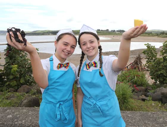 Ellie McGarry and Orla McHenry tries some dulse and yellow man from the Dessert Bar in  Ballycastle, a family business that has been procuring Dulse and making Yellow Man for generations for thousands who descend on Ballycastle for the 400-year-old Lammas Fair. PICTURE KEVIN MCAULEY/MCAULEY MULTIMEDIA