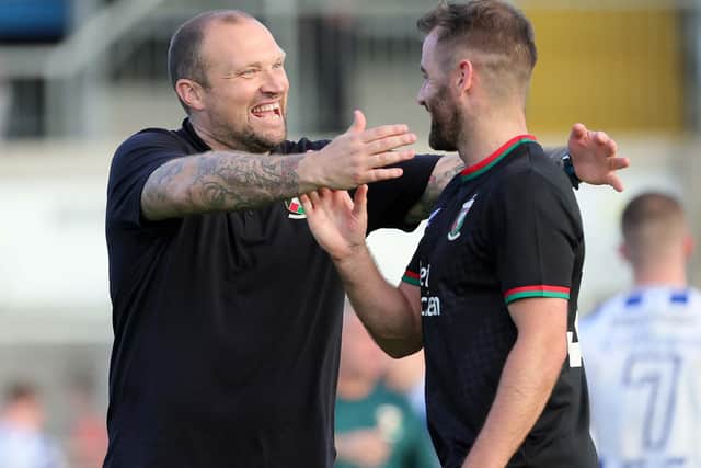 Glentoran manager Warren Feeney embraces two goal hero Niall McGinn after their victory at Newry Showgrounds, Newry. PIC: David Maginnis/Pacemaker Press
