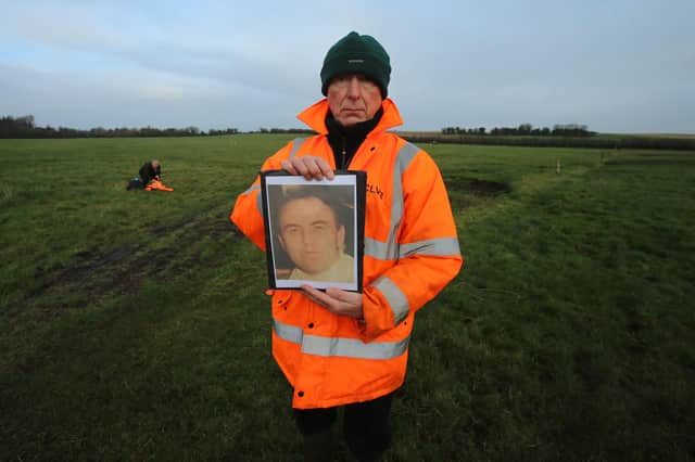 Lead investigator Geoff Knupfer, from the International Commission for the Location of Victims Remains (ICVLR) holding a picture of former Cistercian monk Joe Lynskey during the search of a field in Coghalstown, Co Meath