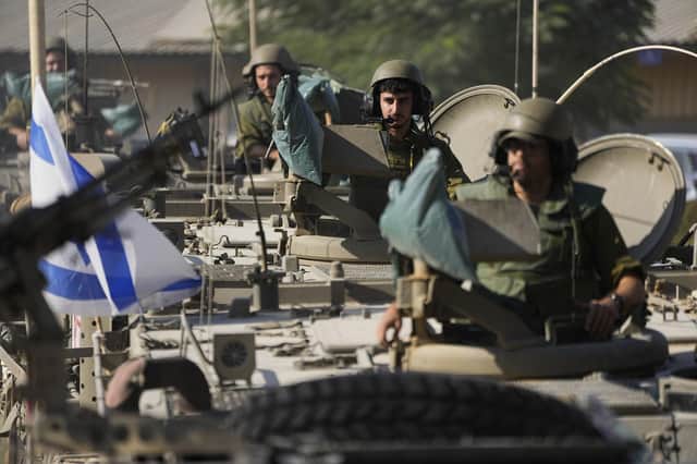 Israeli soldiers gather in a staging area near the border with the Gaza Strip, in southern Israel, yesterday. Israel's response to the Hamas terrorist attacks 'should be measured and directed at chosen targets, but that is not always possible in the heat of war', writes Clive Maxwell