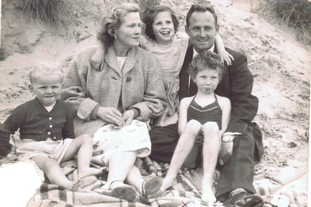 Jenny as a cheeky five-year-old on the right pulling a face with her father James, mother Josephine, sister Rosie and brother Robert during a day out at the beach