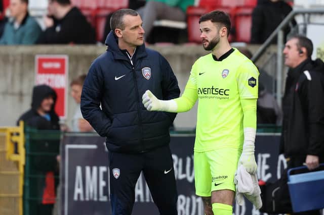 Coleraine manager Oran Kearney speaks to goalkeeper Rory Brown ahead of the second-half at Solitude