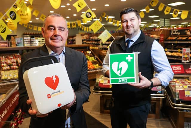 34 lifesaving defibrillators have been installed in Musgrave stores, an  investment of £65,000. Pictured are Trevor Magill, managing director of Musgrave NI, with Martin Reynolds, manager at SuperValu Lisburn