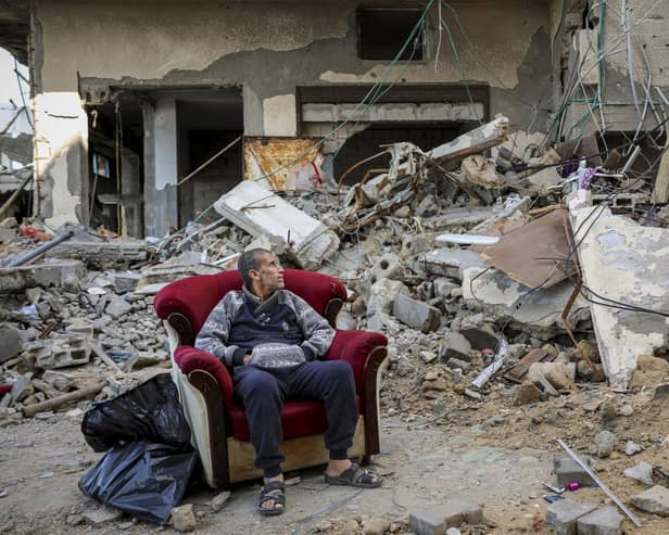 A Palestinian man sits in an armchair outside a destroyed building in Gaza City on Wednesday. (AP Photo/Mohammed Hajjar)
