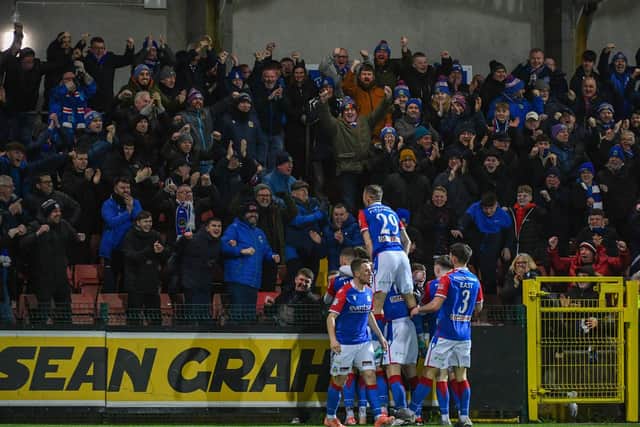 Linfield players celebrate after Daniel Finlayson netted a header against Cliftonville