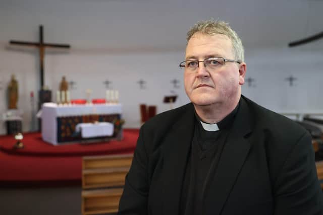 Parish priest Father John Joe Duffy at St Michael's church in the village of Creeslough in Co Donegal, where they have opened a book of condolence for the victims of the explosion at Applegreen service station on Friday.