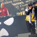 Kneecap - JJ O'Dochartaigh (DJ Provai), Liam Og O Hannaidh (Mo Chara) and Naoise O Caireallain (Moglai Bap) - perform on stage at London's Finsbury Park, as support act to headliners Fontaines DC in summer 2025. Photo: Jeff Moore/PA Wire