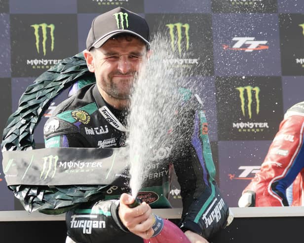 Michael Dunlop sprays the victory champagne after winning the opening Supersport race on Saturday to equal his uncle Joey's record of 26 Isle of Man TT wins