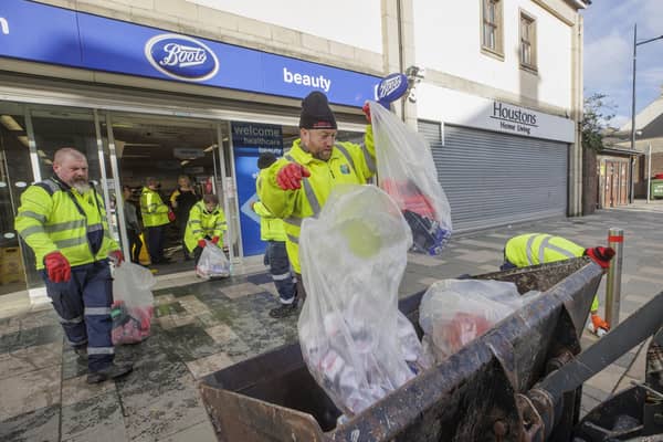 Council workers from Newry, Mourne and Down District Council help clean up flood-stricken Downpatrick, Co Down, on Monday. Pic:: Liam McBurney/PA Wire