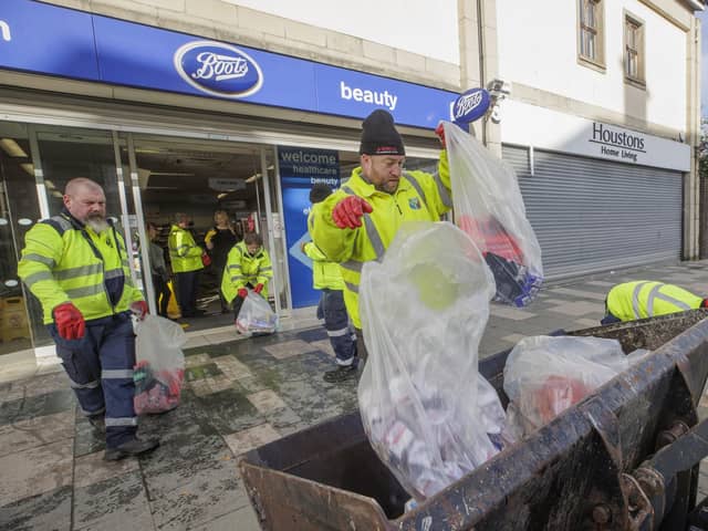 Council workers from Newry, Mourne and Down District Council help clean up flood-stricken Downpatrick, Co Down, on Monday. Pic:: Liam McBurney/PA Wire