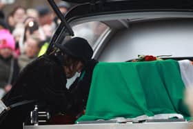 Victoria Mary Clarke, wife of Shane MacGowan, pays respects to his coffin as it arrives for the funeral of Shane MacGowan at Saint Mary's of the Rosary Church, Nenagh, Co. Tipperary. MacGowan, who found fame as the lead singer of London-Irish punk/folk band The Pogues, died at the age of 65 last week. Photo: Niall Carson/PA Wire