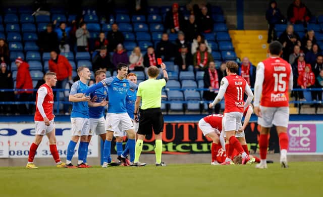 Robbie Garrett receives a red card from referee Keith Kennedy during tonight's clash between Glenavon and Larne at Mourneview Park