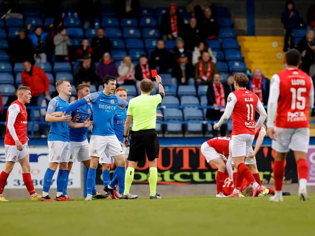 Robbie Garrett receives a red card from referee Keith Kennedy during tonight's clash between Glenavon and Larne at Mourneview Park