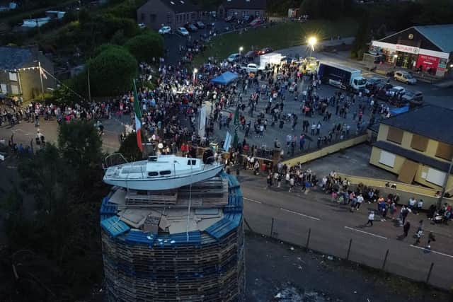 People watch as the pyre with a boat on top, with a picture of Taoiseach Leo Varadkar and a banner that reads "Good Friday Agreement ? That ship has sailed", is about to be set alight in Moygashel near Dungannon, Co Tyrone
