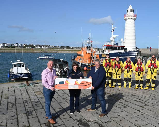 Maghaberry Prison Governor David Savage and Horticulture Officer James Carson present a cheque for £4,500 to Ann Couser from the Donaghadee RNLI Fundraising Team. Picture: Michael Cooper
