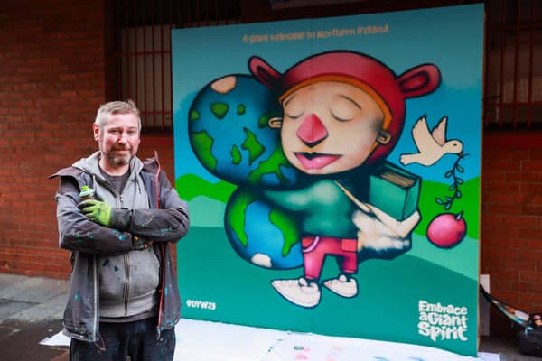 Embargoed to 0001 Wednesday October 4

Artist Kev Largeyoutside the Oh Yeah Music Centre, with his artwork commissioned by Tourism Northern Ireland for One Young World 2023 Belfast Summit. Picture date: Tuesday October 3, 2023. PA Photo. See PA story ULSTER Youth Mural. Photo credit should read: Liam McBurney/PA Wire 