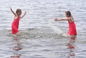 Twins Ellie and Eireann enjoying the weather at Lough Shore Park in Antrim on Bank Holiday Monday. Pic: Colm Lenaghan/Pacemaker