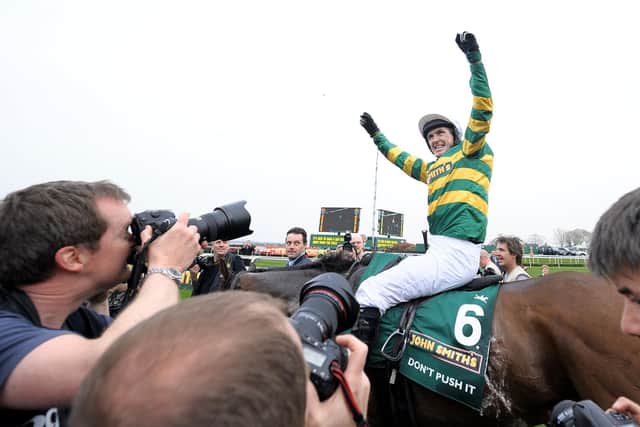 AP McCoy celebrates winning the Grand National on Don't Push It in 2010