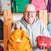 Northern Ireland social enterprise Madlug is celebrating its eighth birthday by marking a significant milestone of distributing 75,000 pack-away travel bags to children in care.  It puts them well on their way to reaching the 100,000 target by next year while the bag was also recently featured in the Take That musical film Greatest Days starring Aisling Bea. Pictured is Madlug founder Dave Linton