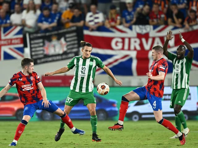 Aris Limassol's defender Julius Szoke fights for the ball with Rangers' Scott Wright and John Lundstram in the Europa League match at the Alphamega Stadium