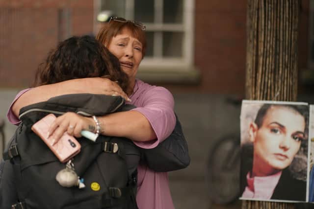 Women embrace during the event in Dublin in memory of Sinead O'Connor