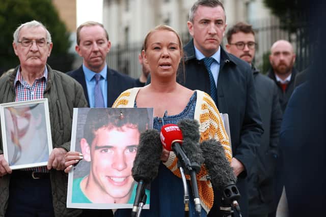 Seana Quinn holding an image of her brother Dwayne O'Donnell joins families of Phelim McNally, Thomas Casey, Sean Anderson, Dwayne O'Donnell and Thomas Armstrong gathered outside Belfast High Court, as the Attorney General for Northern Ireland, Brenda King, has directed that fresh Inquests be held into their deaths. Photo: Liam McBurney/PA Wire