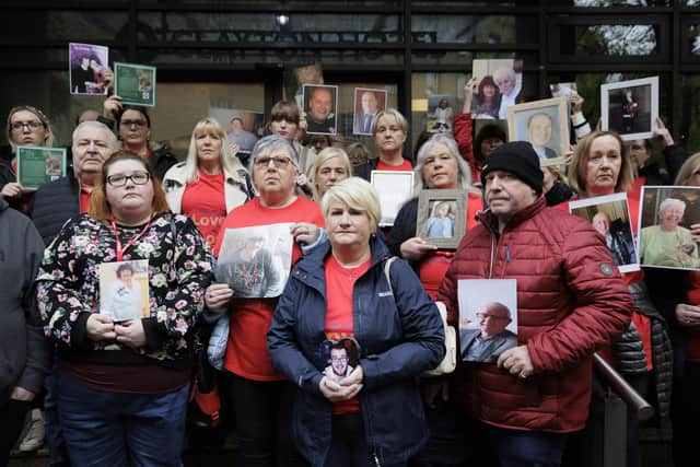 Members of Northern Ireland Covid-19 Bereaved Families for Justice stand together holding images of their loved ones outside the Clayton Hotel in Belfast as the Covid-19 Inquiry holds its first day of hearings in Northern Ireland