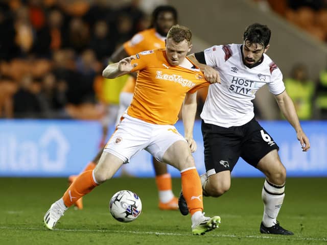 Blackpool's Shayne Lavery (left) and Derby County's Eiran Cashin battle for the ball during a Sky Bet League One match at Bloomfield Road, Blackpool. PIC: Richard Sellers/PA Wire