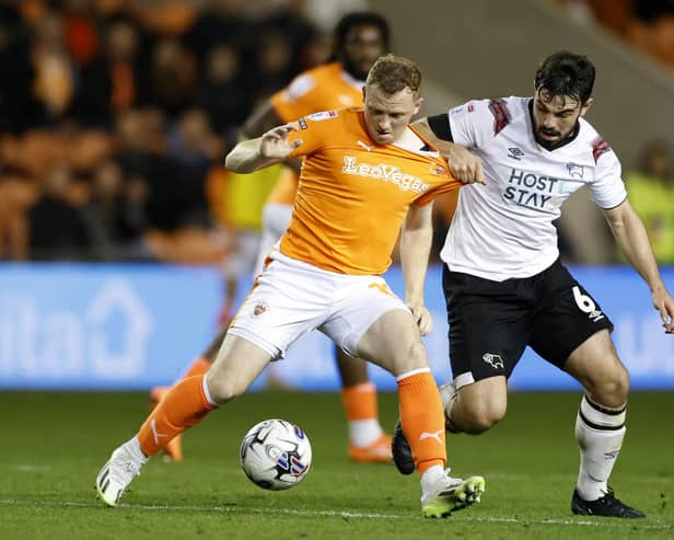 Blackpool's Shayne Lavery (left) and Derby County's Eiran Cashin battle for the ball during a Sky Bet League One match at Bloomfield Road, Blackpool. PIC: Richard Sellers/PA Wire