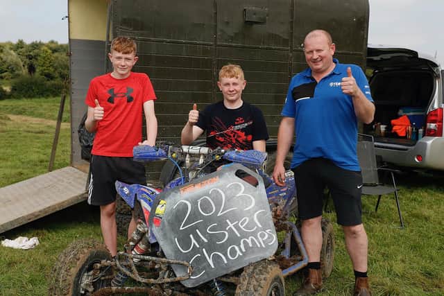 Tandragee’s Jack Minish pictured with his dad Jeff and brother Harry after winning the clubman quad Ulster championship 