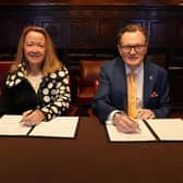 Olivia ‘Libby’ Duane Adams, Alteryx co-founder, and vice chancellor of Queen's, Professor Sir Ian Greer, sign the agreement in New York for the largest in-kind donation the university has received. Alteryx will be donating data licences to students and staff at the university with an estimated value of 15 million dollars (£11.8 million)