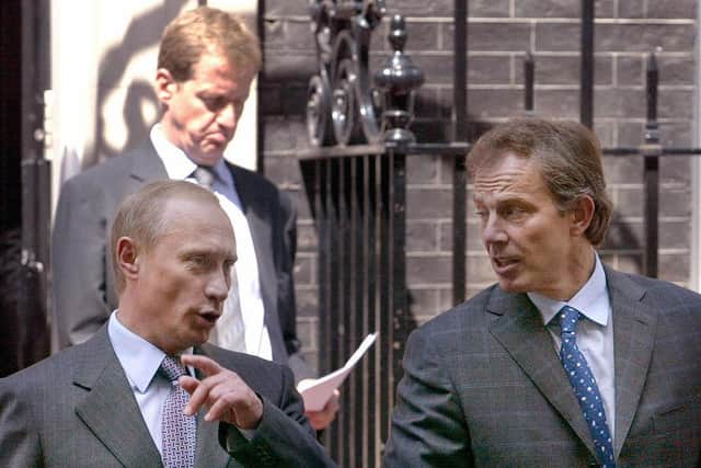 British Prime Minister Tony Blair and Russian President Vladimir Putin, followed by Blair's Director of Communication Alistair Campbell, leave Number 10 Downing Street on June 26, 2003 (GRIGORY DUKOR/AFP via Getty Images)
